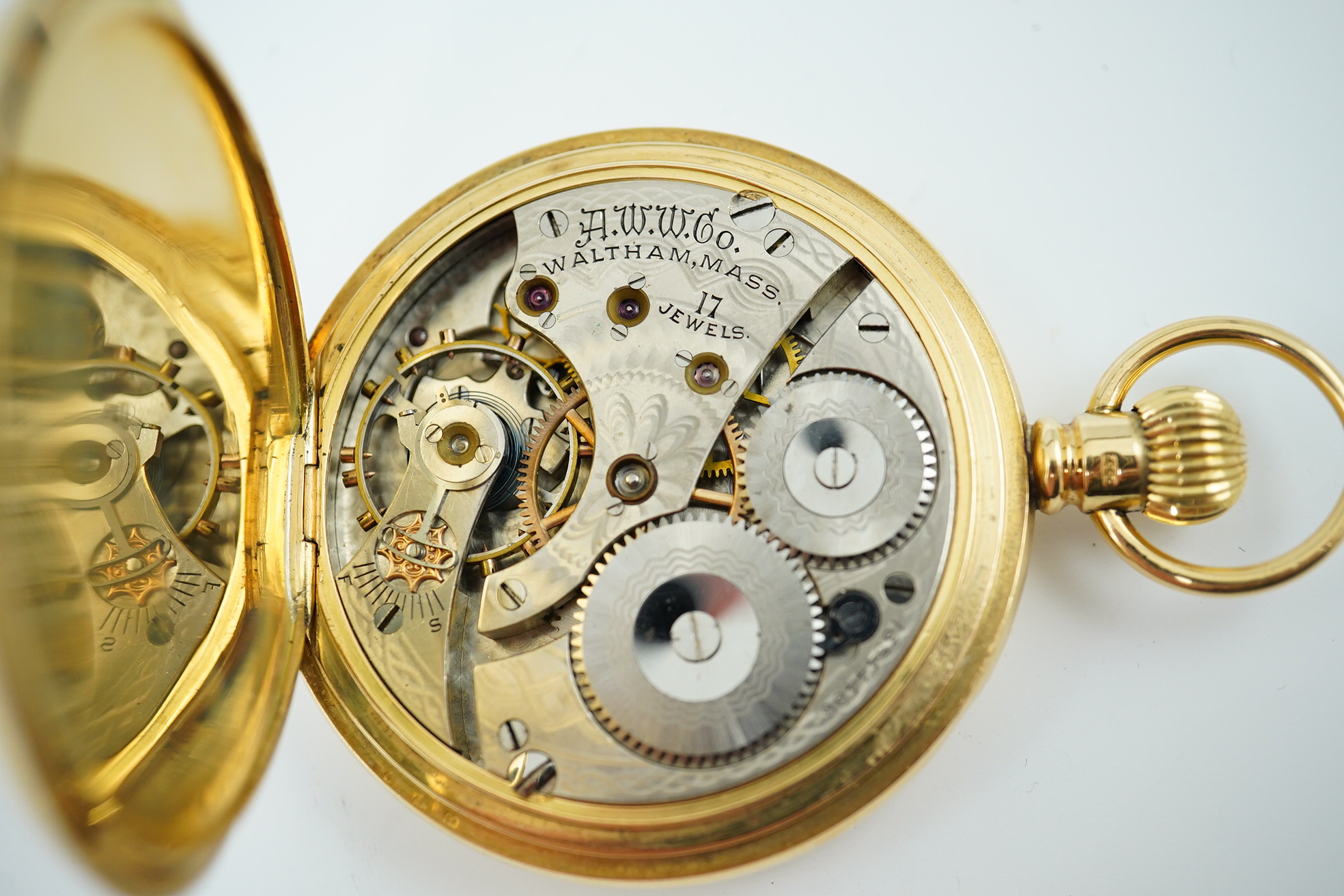 An Edwardian engine turned 18ct gold Waltham hunter keyless pocket watch